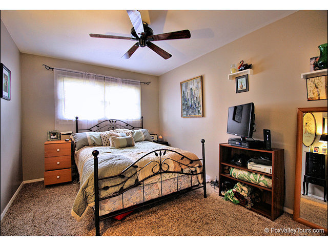56 Sheffield Road Montgomery, IL 60538 - Photo 11 of 18 a bedroom with a bed and a flat screen tv