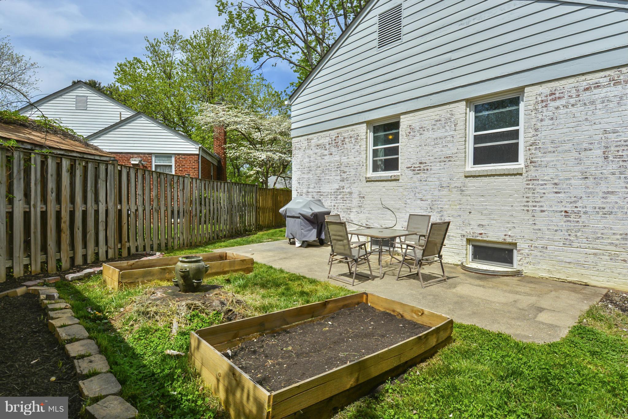 501 Royalton Road Silver Spring, MD 20901 - Photo 27 of 29 a view of a backyard with table and chairs with wooden fence and plants