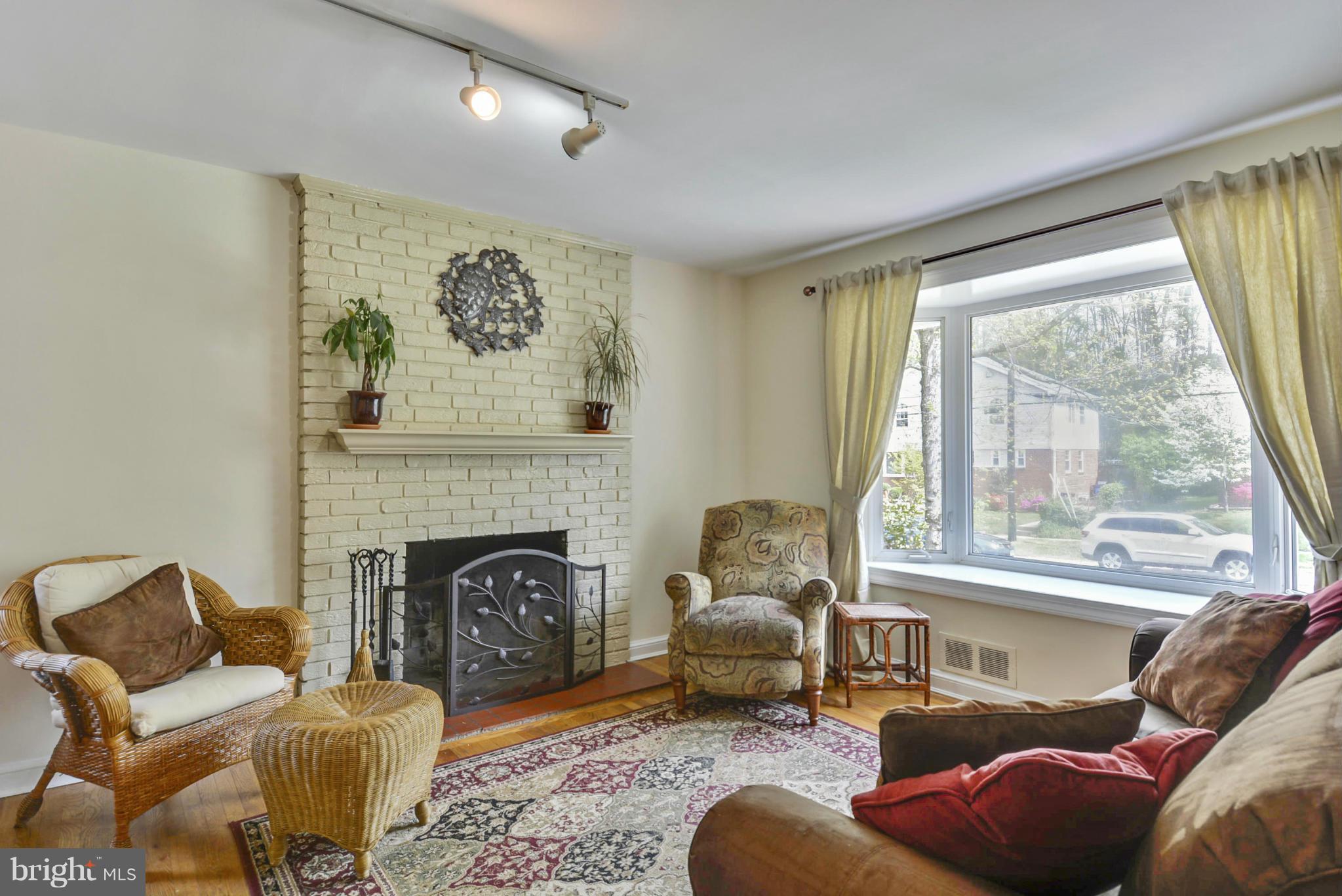 501 Royalton Road Silver Spring, MD 20901 - Photo 5 of 29 a living room with furniture window and a fireplace
