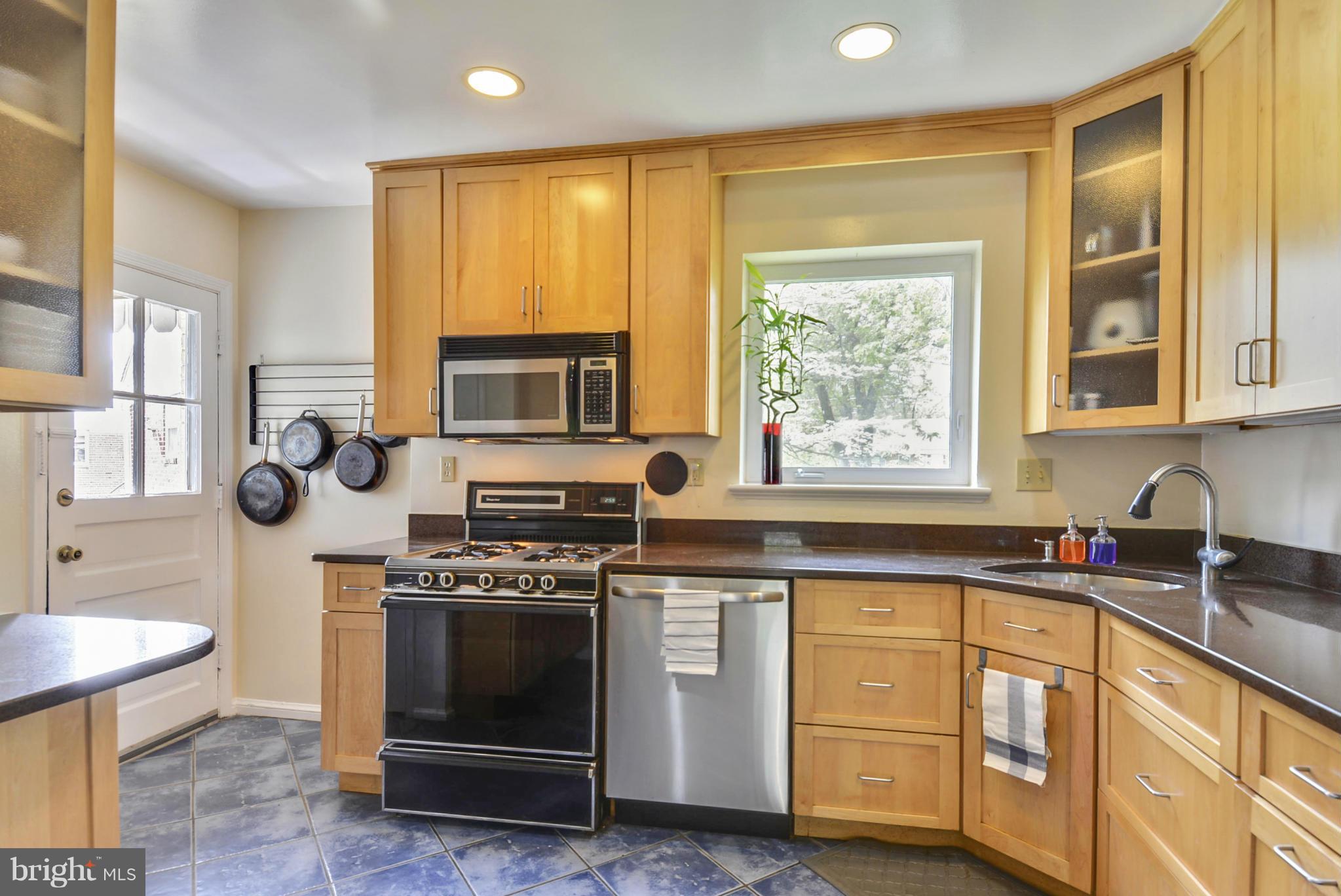 501 Royalton Road Silver Spring, MD 20901 - Photo 10 of 29 a kitchen with stainless steel appliances a stove sink and microwave