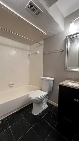 a bathroom with a toilet a sink and bathtub