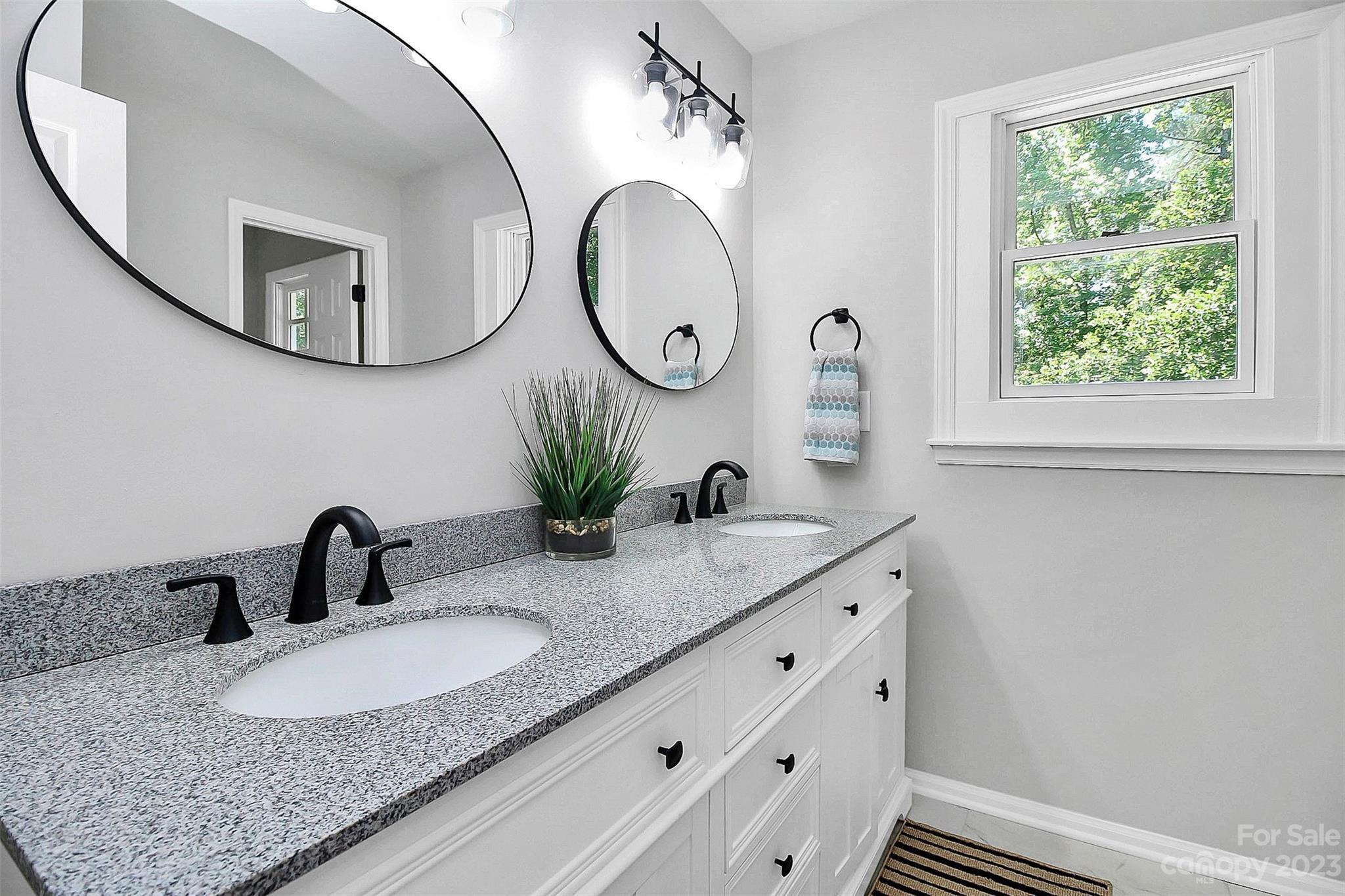5218 Rehobeth Road Waxhaw, NC 28173 - Photo 22 of 35 a bathroom with a granite countertop sink and a mirror