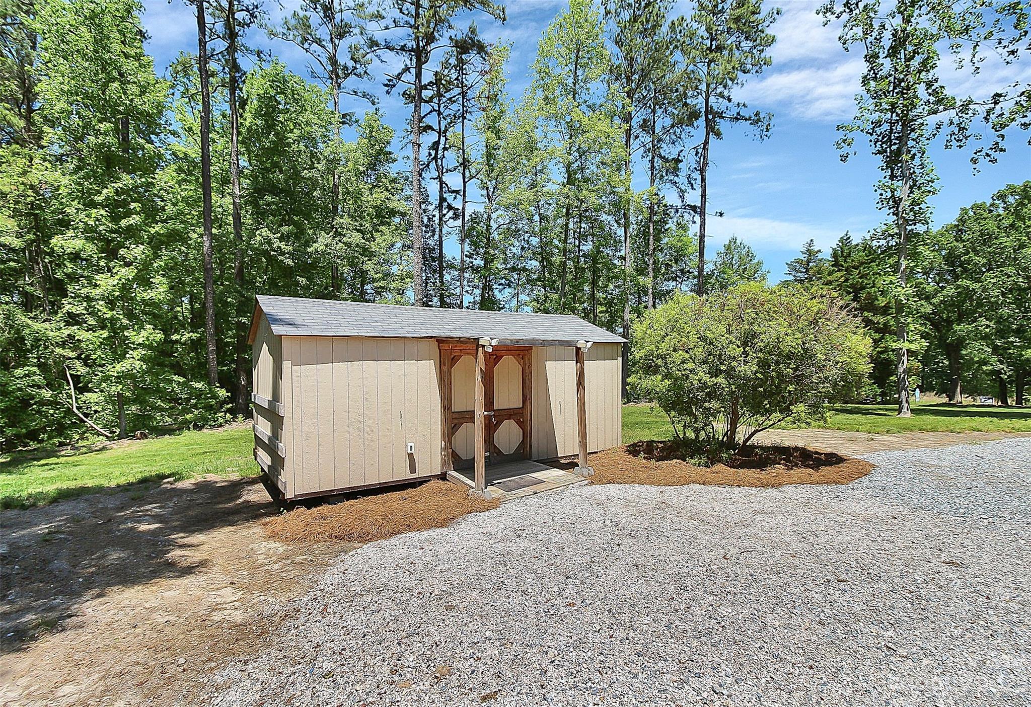 5218 Rehobeth Road Waxhaw, NC 28173 - Photo 28 of 35 a backyard of a house with yard and trampoline
