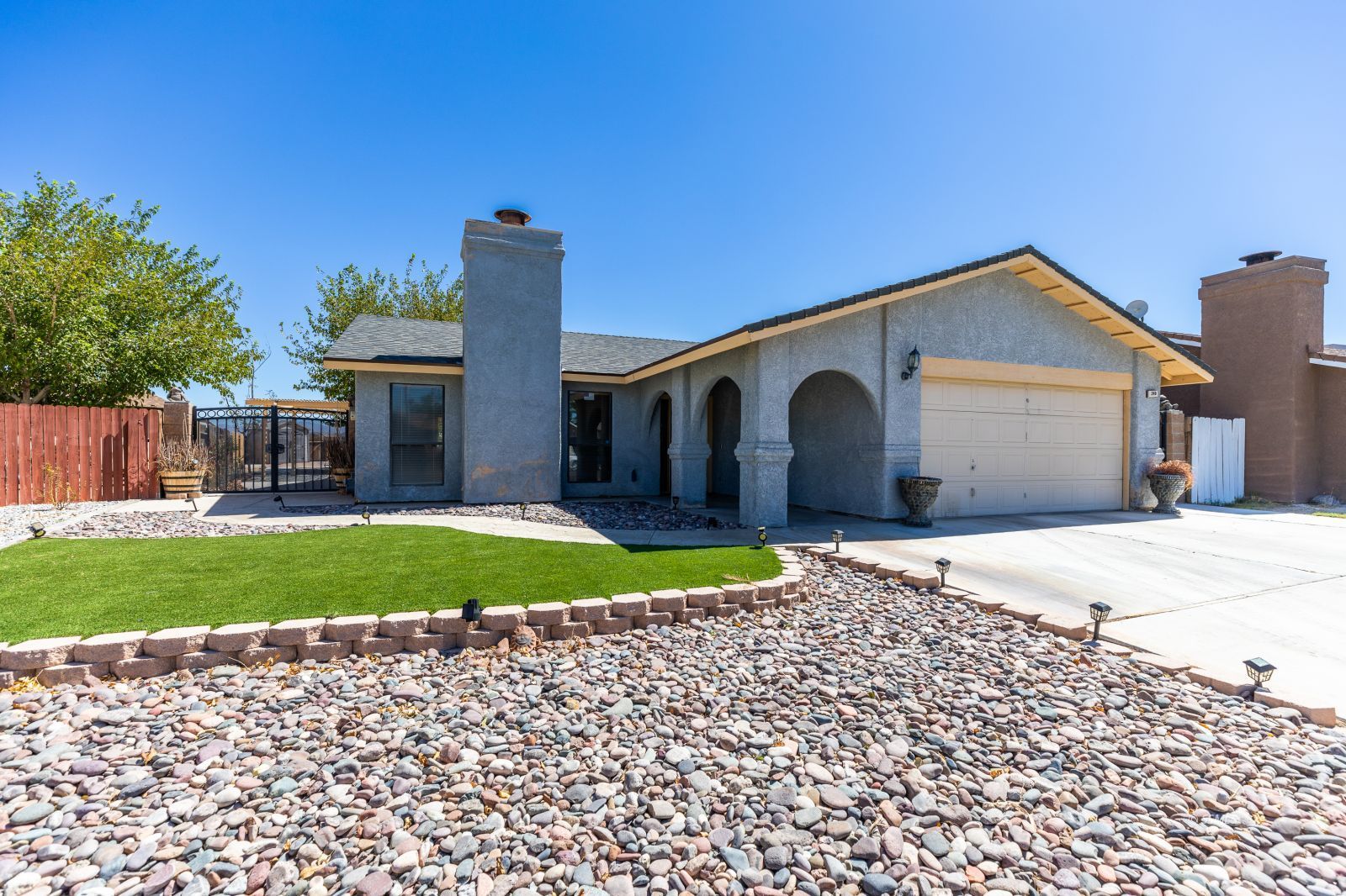 240 Richard Court Ridgecrest, CA 93555 - Photo 1 of 34 a front view of a house with a yard and a garage