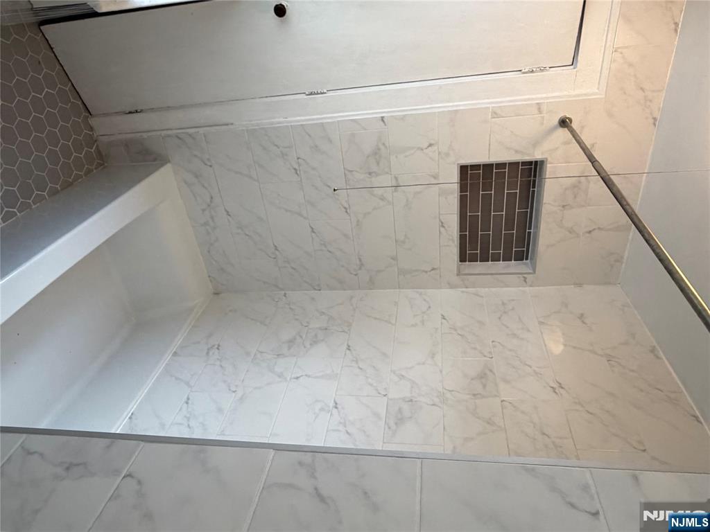 154 Clinton Place, Unit 2 Hackensack, NJ 07601 - Photo 9 of 11 a bathroom with a bathtub