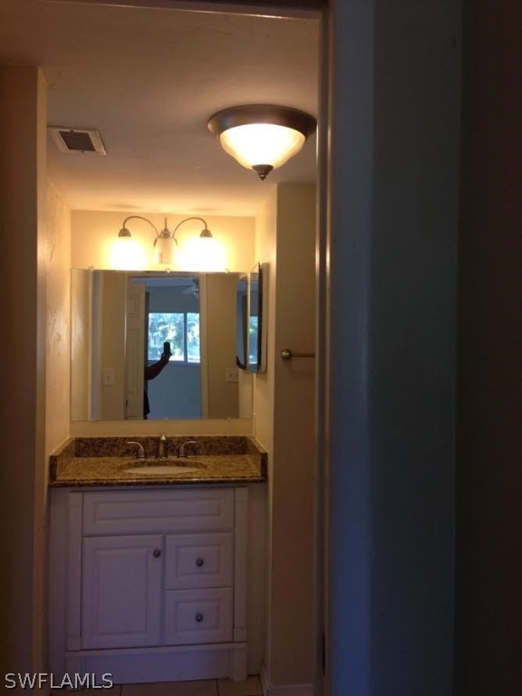 8162 Country Road, Unit 104 Fort Myers, FL 33919 - Photo 11 of 13 a bathroom with a sink and a mirror