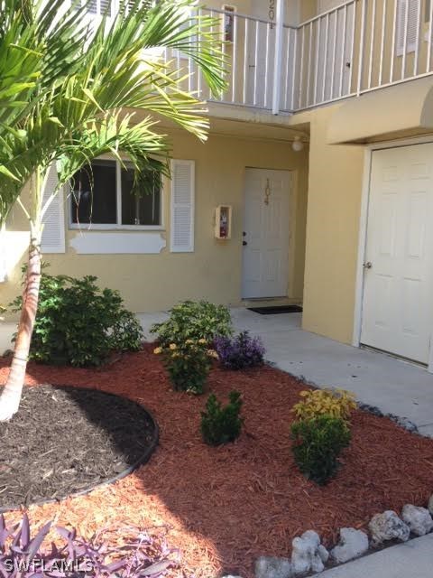 8162 Country Road, Unit 104 Fort Myers, FL 33919 - Photo 4 of 13 a front view of a house having yard