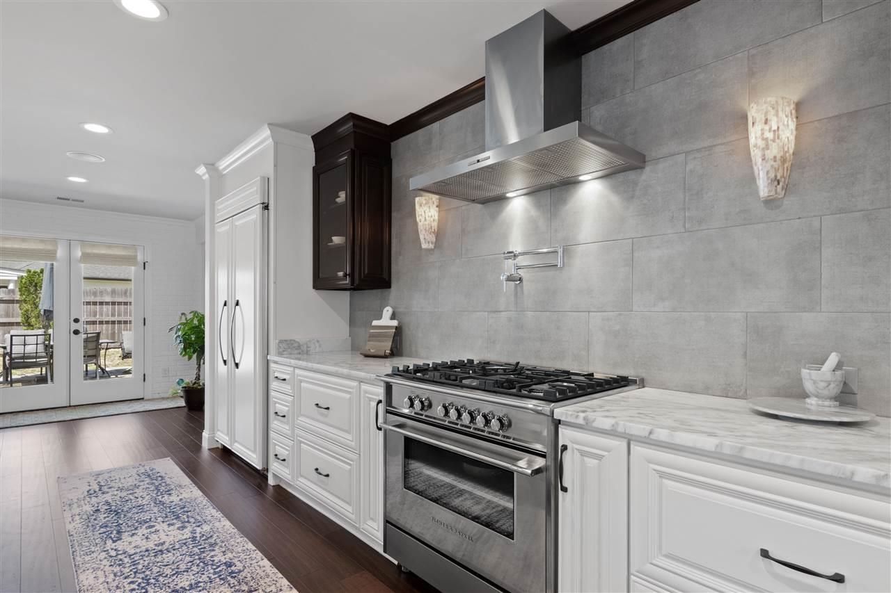 1911 Brierbrook Road Germantown, TN 38138 - Photo 7 of 26 a kitchen with stainless steel appliances a stove and white cabinets