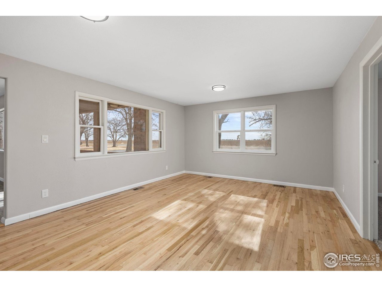 17217 County Road 86 Pierce, CO 80650 - Photo 13 of 49 a view of an empty room with wooden floor and a window