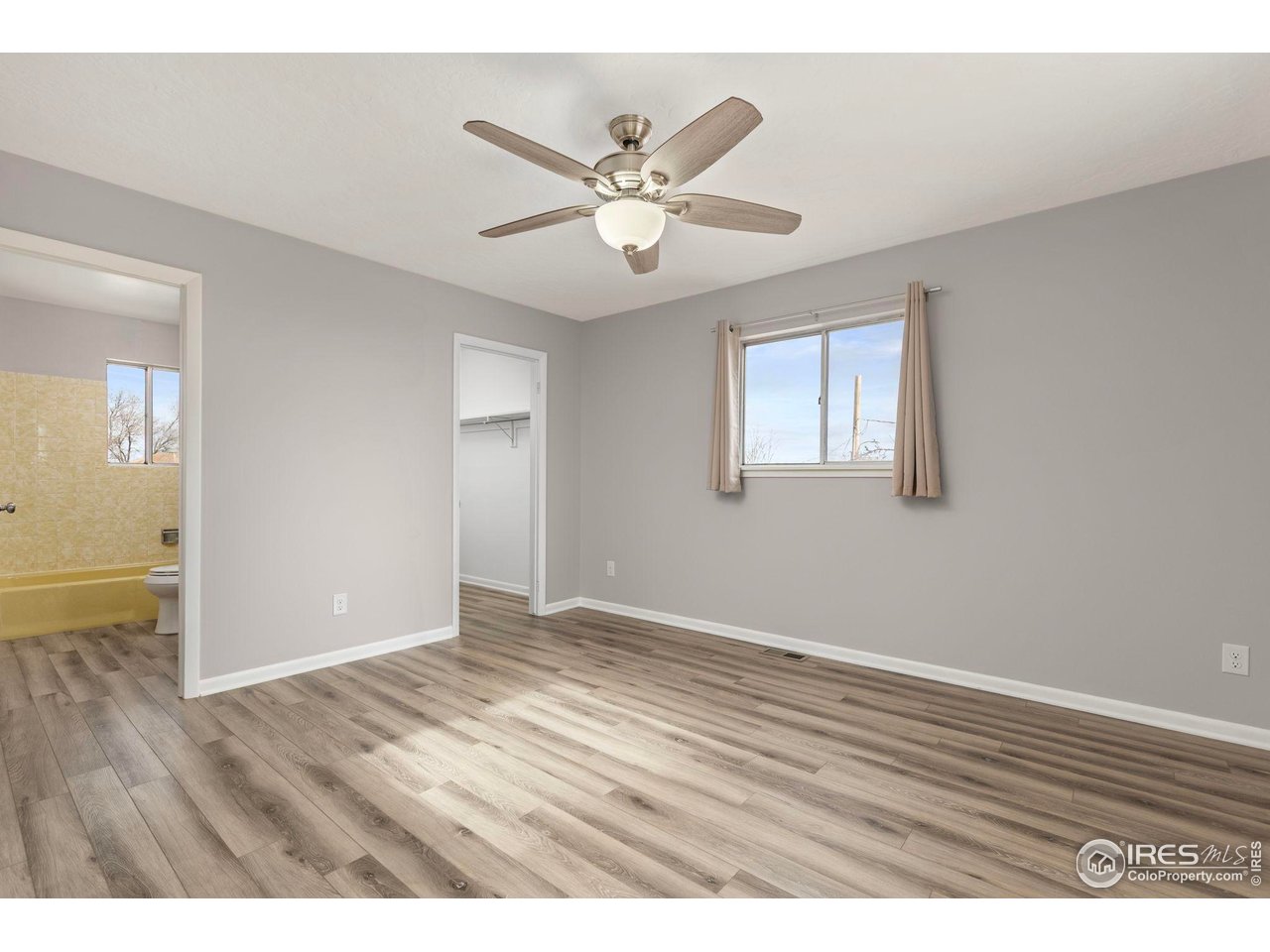 17217 County Road 86 Pierce, CO 80650 - Photo 23 of 49 wooden floor in an empty room with a window