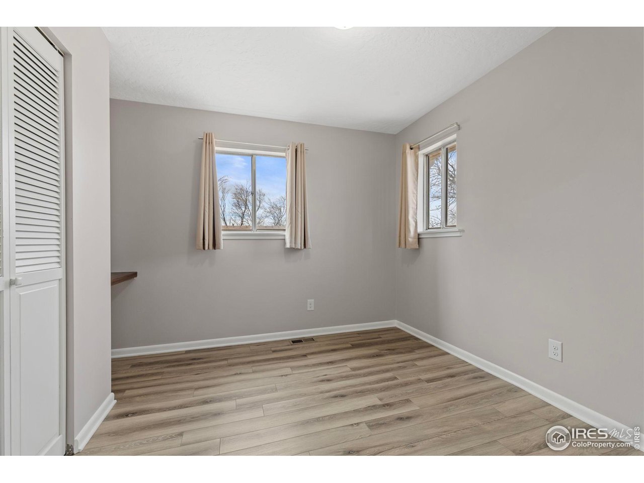 17217 County Road 86 Pierce, CO 80650 - Photo 27 of 49 a view of an empty room with wooden floor and a window