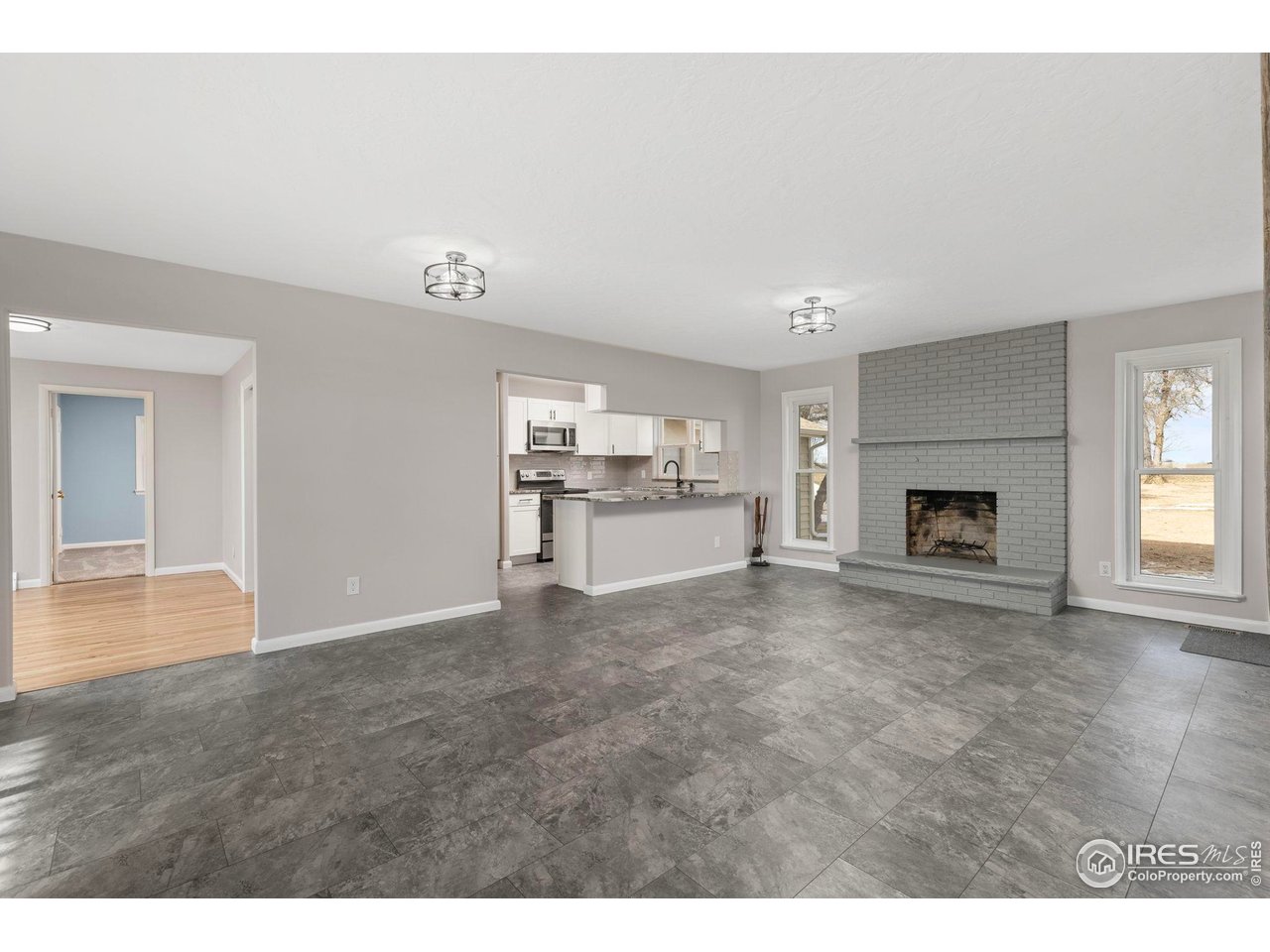 17217 County Road 86 Pierce, CO 80650 - Photo 8 of 49 a view of an empty room with a fireplace and a window