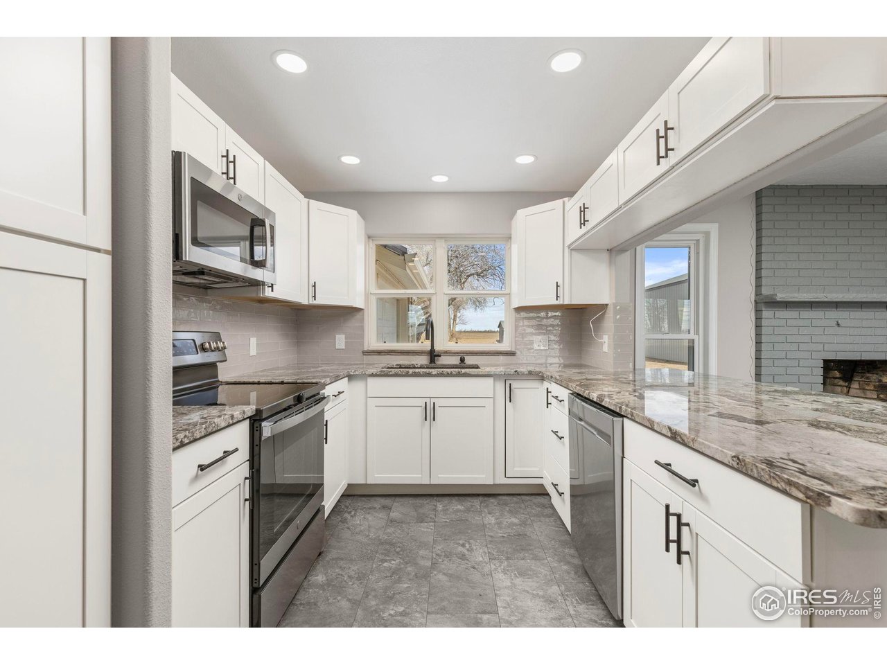 17217 County Road 86 Pierce, CO 80650 - Photo 10 of 49 a kitchen with stainless steel appliances granite countertop a sink and stove top oven