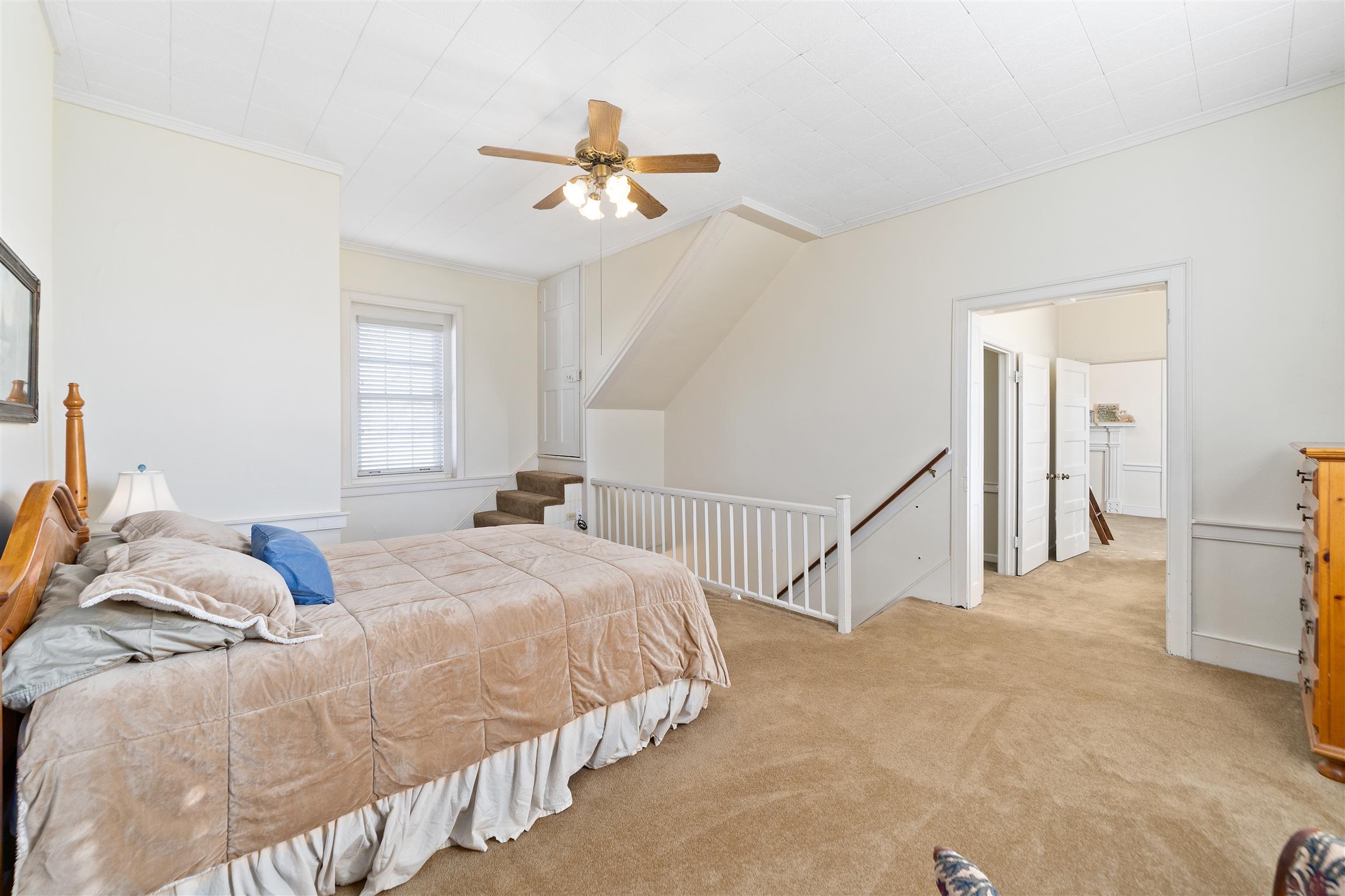 3248 Marthas Chapel Road Cunningham, TN 37052 - Photo 13 of 30 a bedroom with a bed and a chandelier