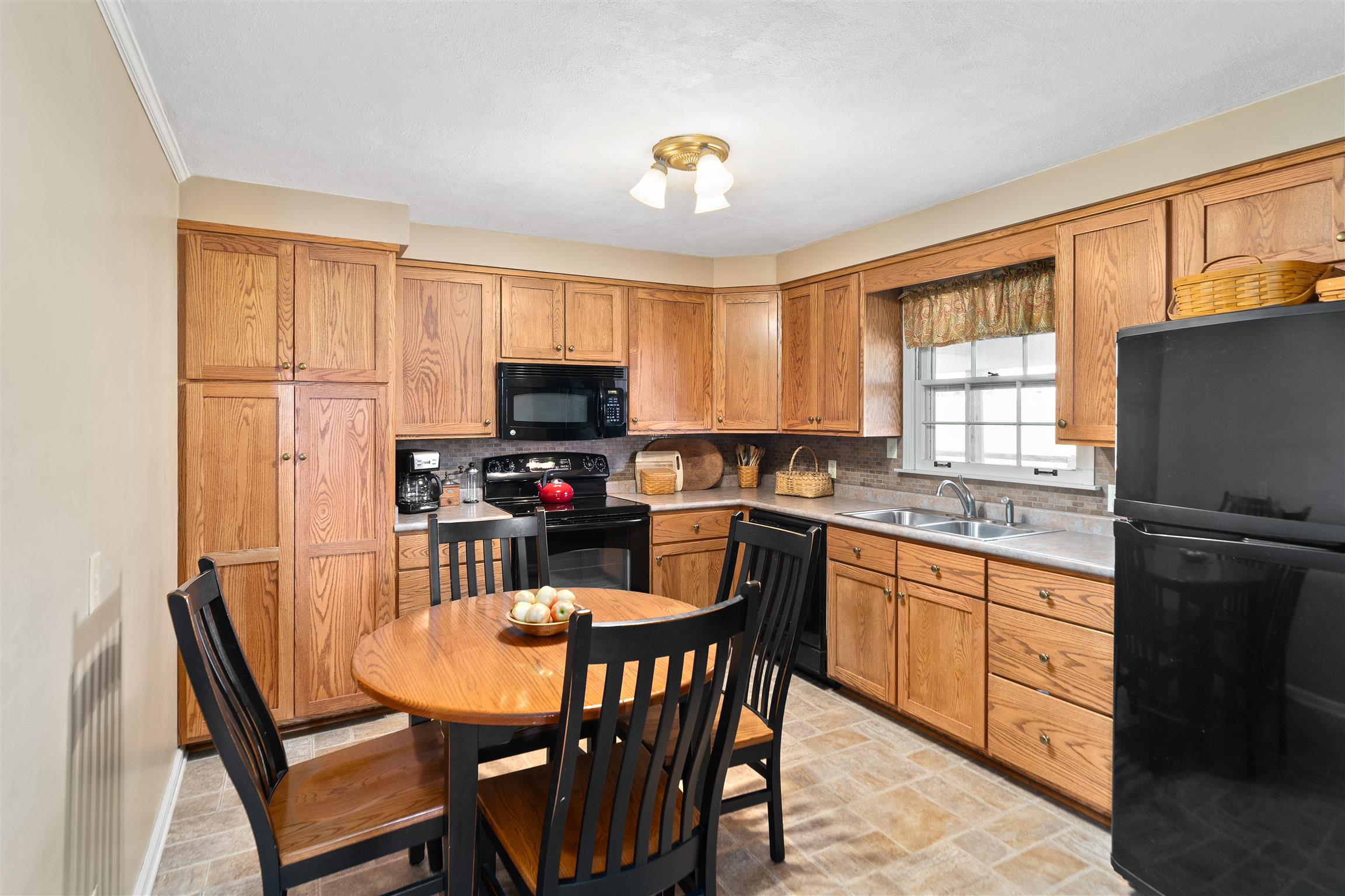 3248 Marthas Chapel Road Cunningham, TN 37052 - Photo 8 of 30 a view of kitchen with sink dining table and chairs