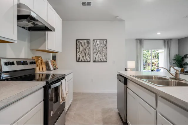 a kitchen that has a sink and a stove