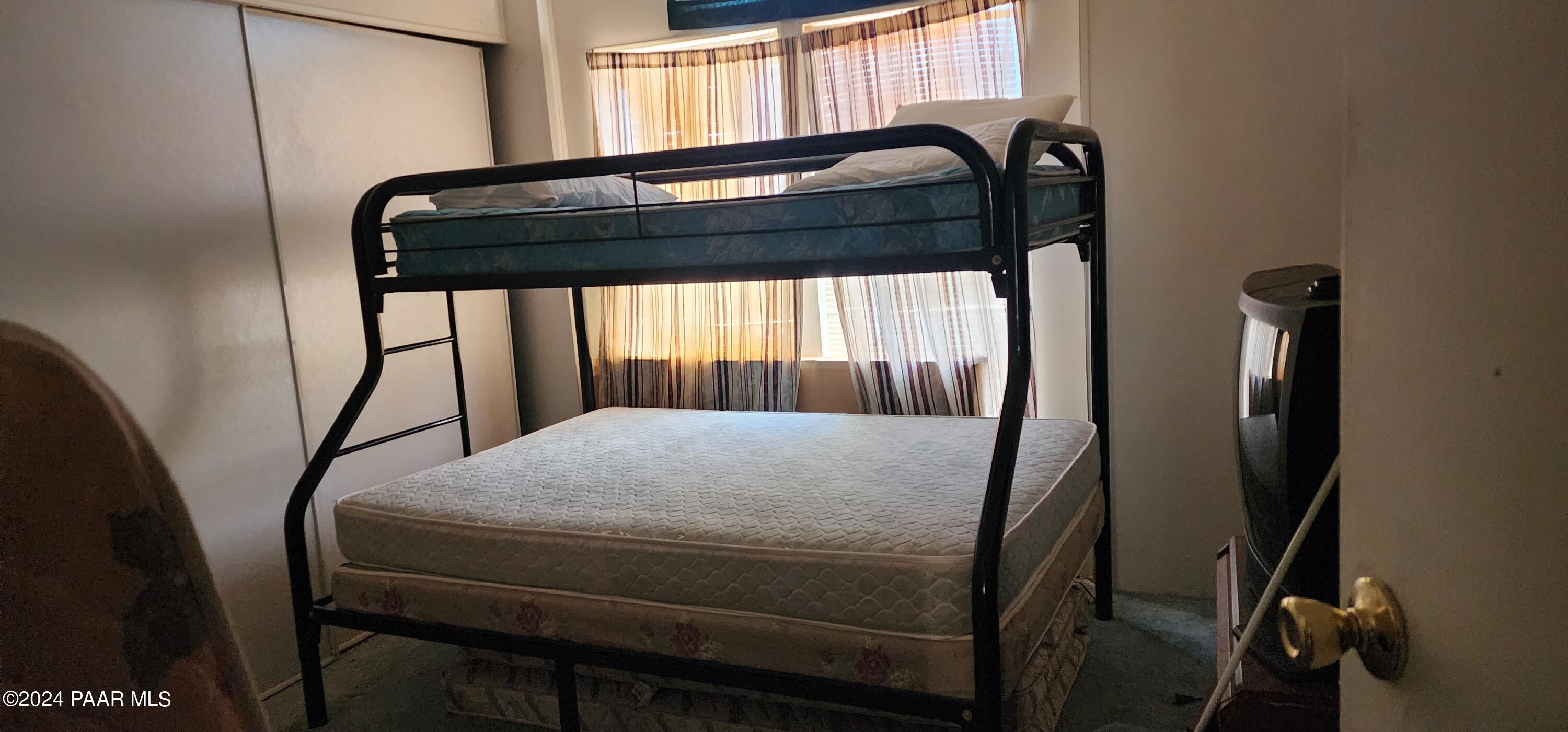 1159 Foothill Road Williams, AZ 86046 - Photo 24 of 31 a bedroom with a bed and window