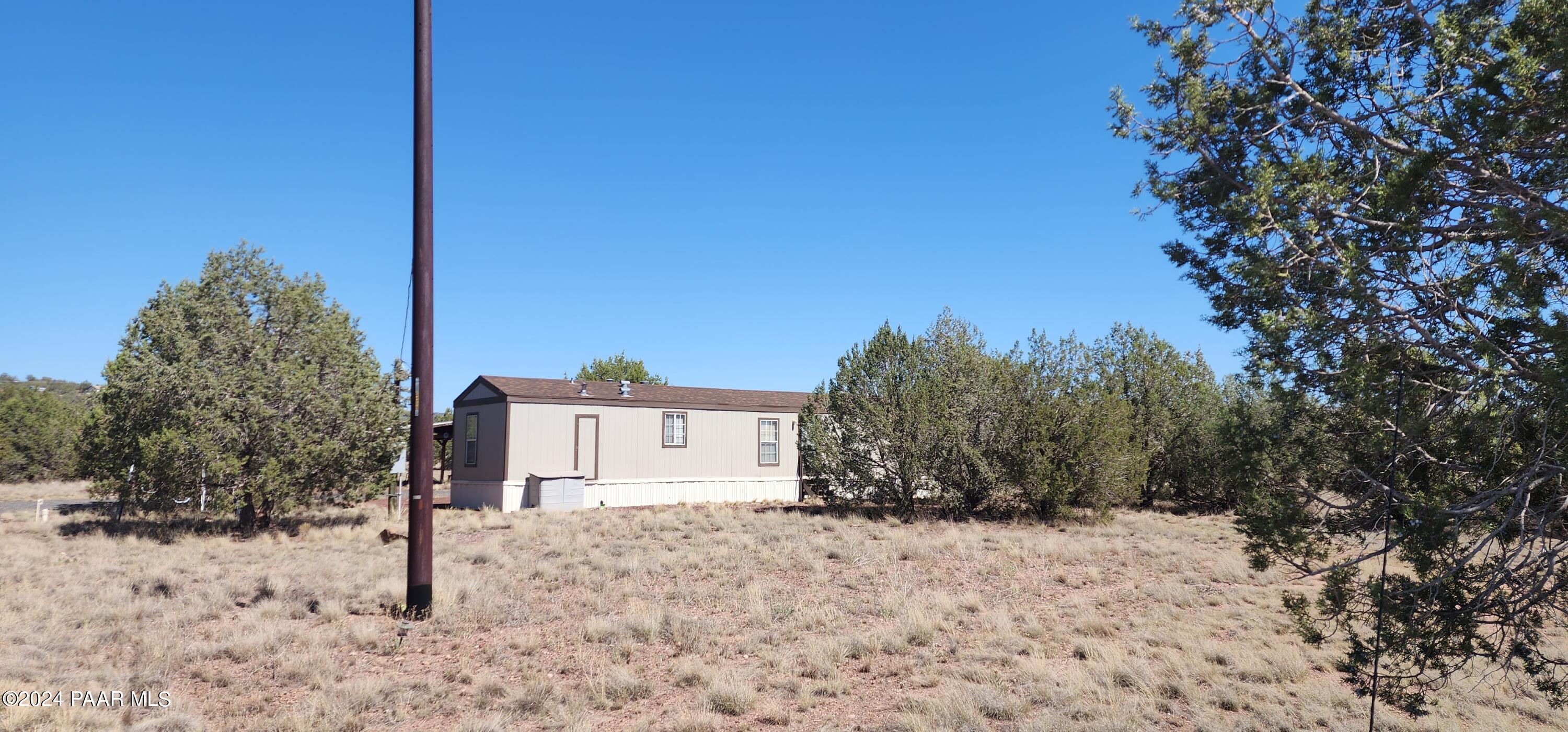 1159 Foothill Road Williams, AZ 86046 - Photo 25 of 31 a view of a yard covered with snow in the background