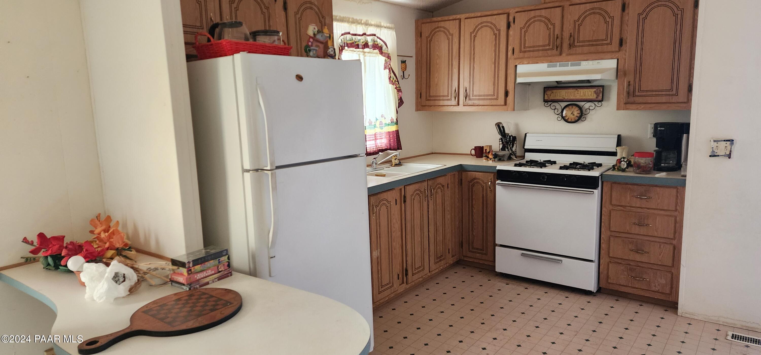 1159 Foothill Road Williams, AZ 86046 - Photo 10 of 31 a kitchen with a refrigerator and a sink