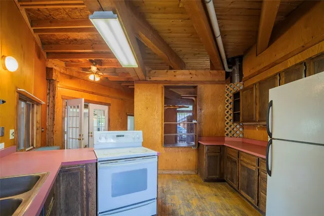 a kitchen with a refrigerator and sink