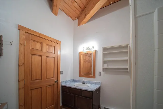 a bathroom with a granite countertop sink and a mirror