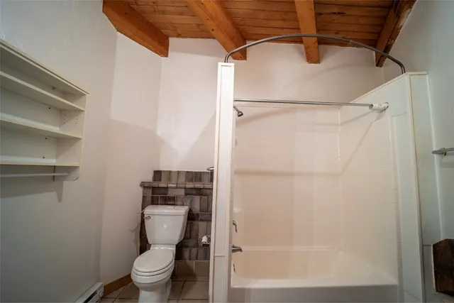 a bathroom with a toilet and a shower