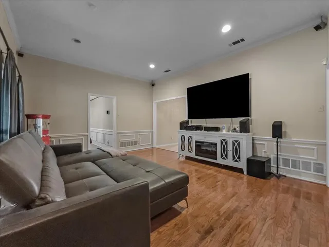 a living room with furniture and wooden floor