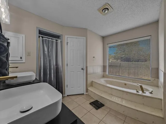 a bathroom with a bathtub and a shower