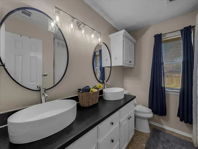 a bedroom with a large bed and a flat tv screen