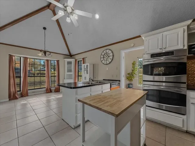 a kitchen with stainless steel appliances granite countertop a sink and a refrigerator