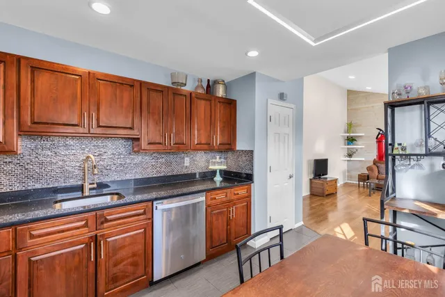 a kitchen with stainless steel appliances granite countertop a refrigerator and sink