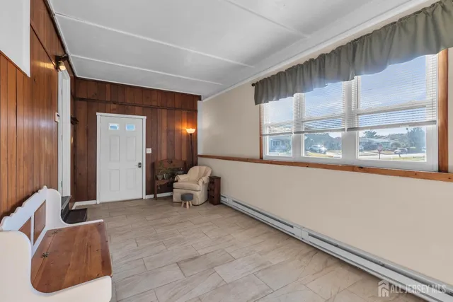 a living room with furniture and large windows