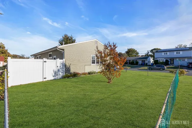 a backyard of a house with lots of green space and fountain