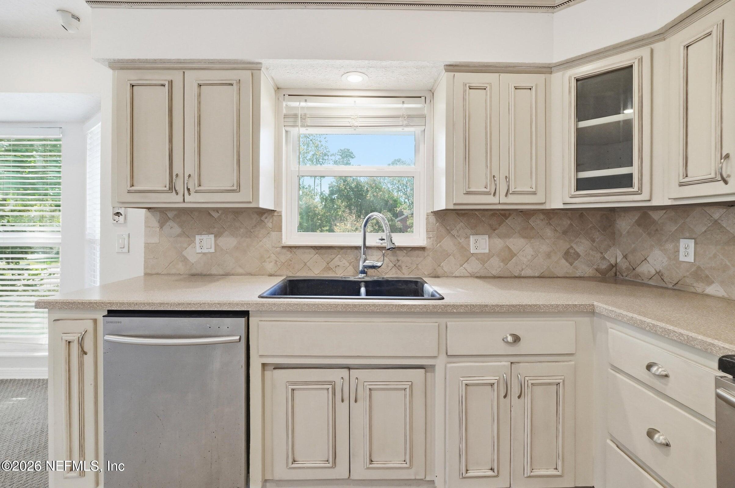 969 Alpine Ridge Court Orange Park, FL 32065 - Photo 12 of 26 a kitchen with white cabinets and a window