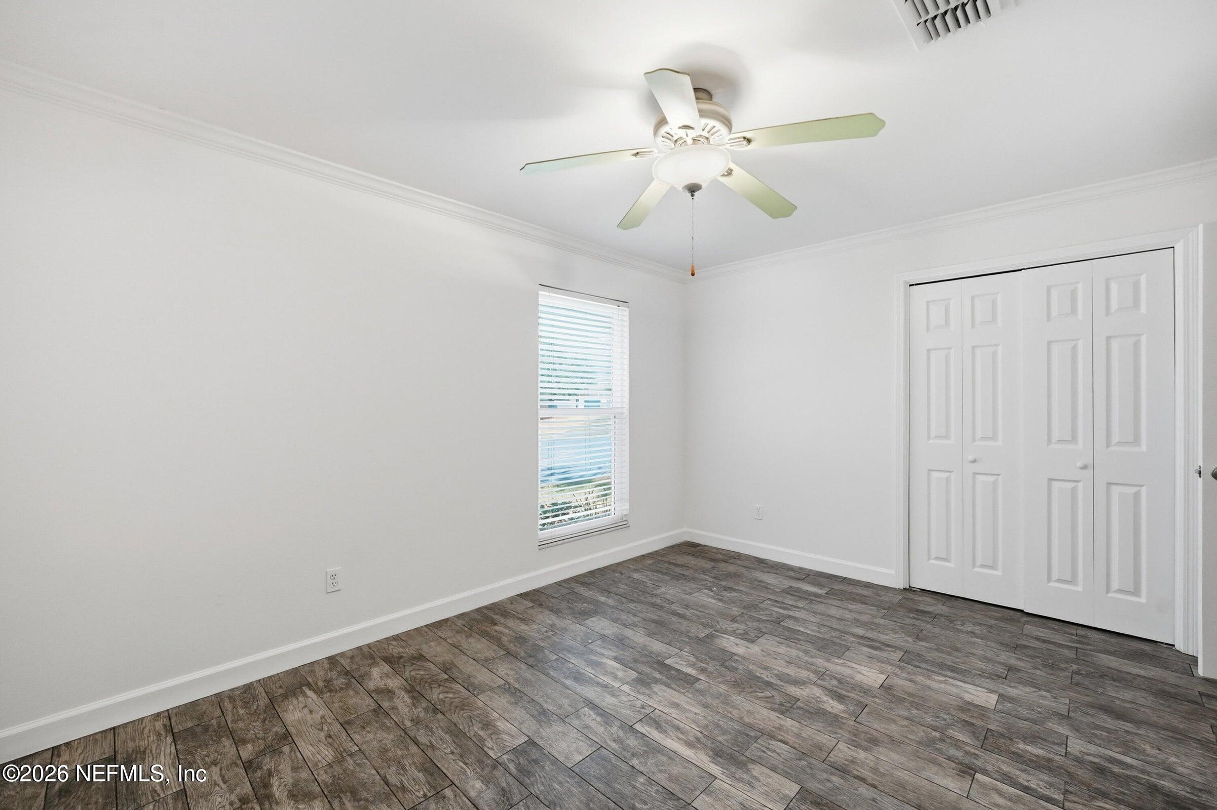 969 Alpine Ridge Court Orange Park, FL 32065 - Photo 19 of 26 wooden floor in an empty room with a window