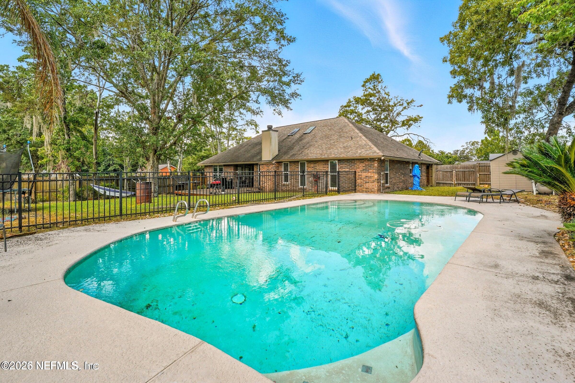 969 Alpine Ridge Court Orange Park, FL 32065 - Photo 2 of 26 a view of a swimming pool with a patio