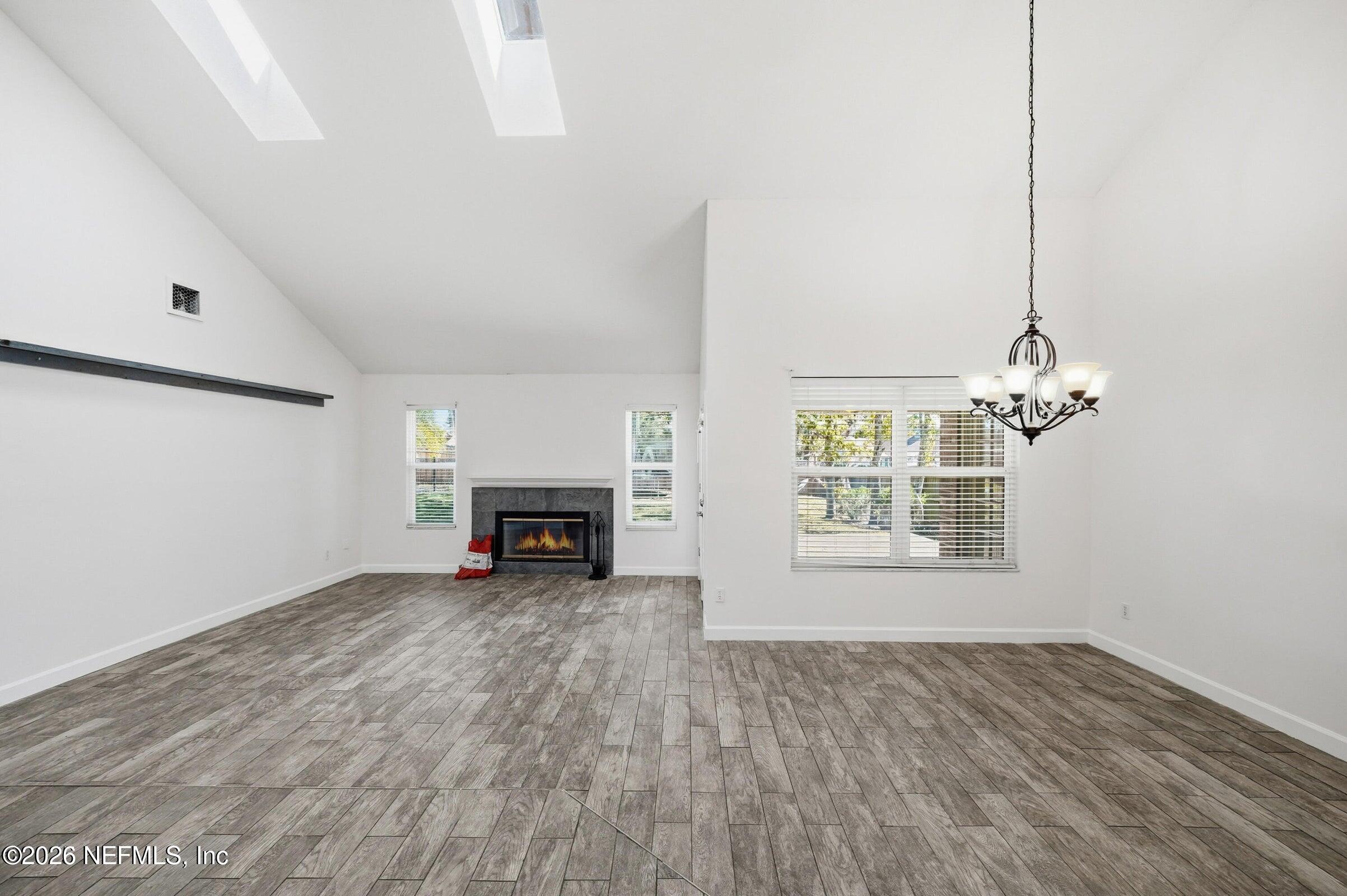 969 Alpine Ridge Court Orange Park, FL 32065 - Photo 4 of 26 an empty room with windows fireplace and windows