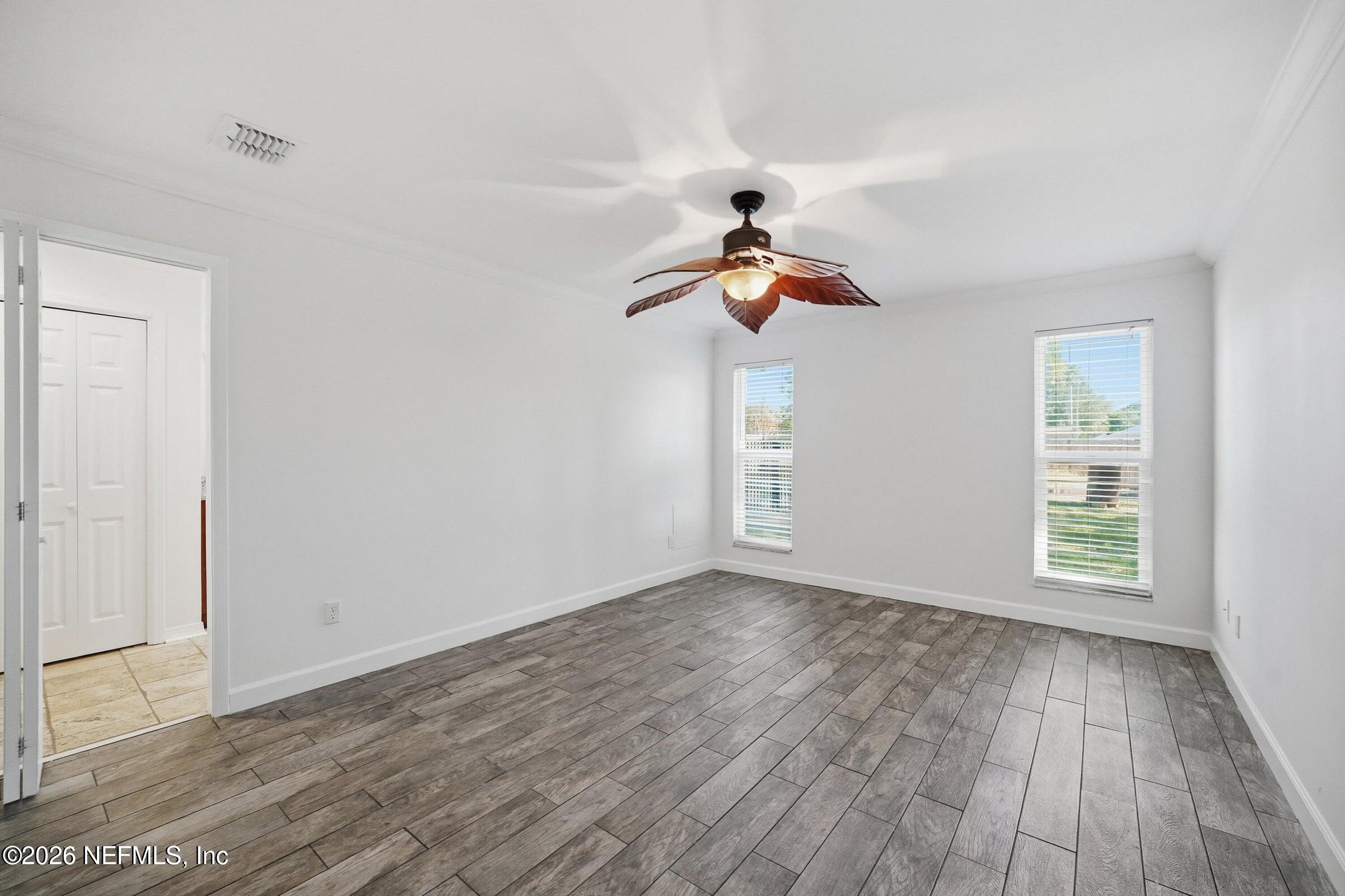 969 Alpine Ridge Court Orange Park, FL 32065 - Photo 5 of 26 wooden floor in an empty room with a window