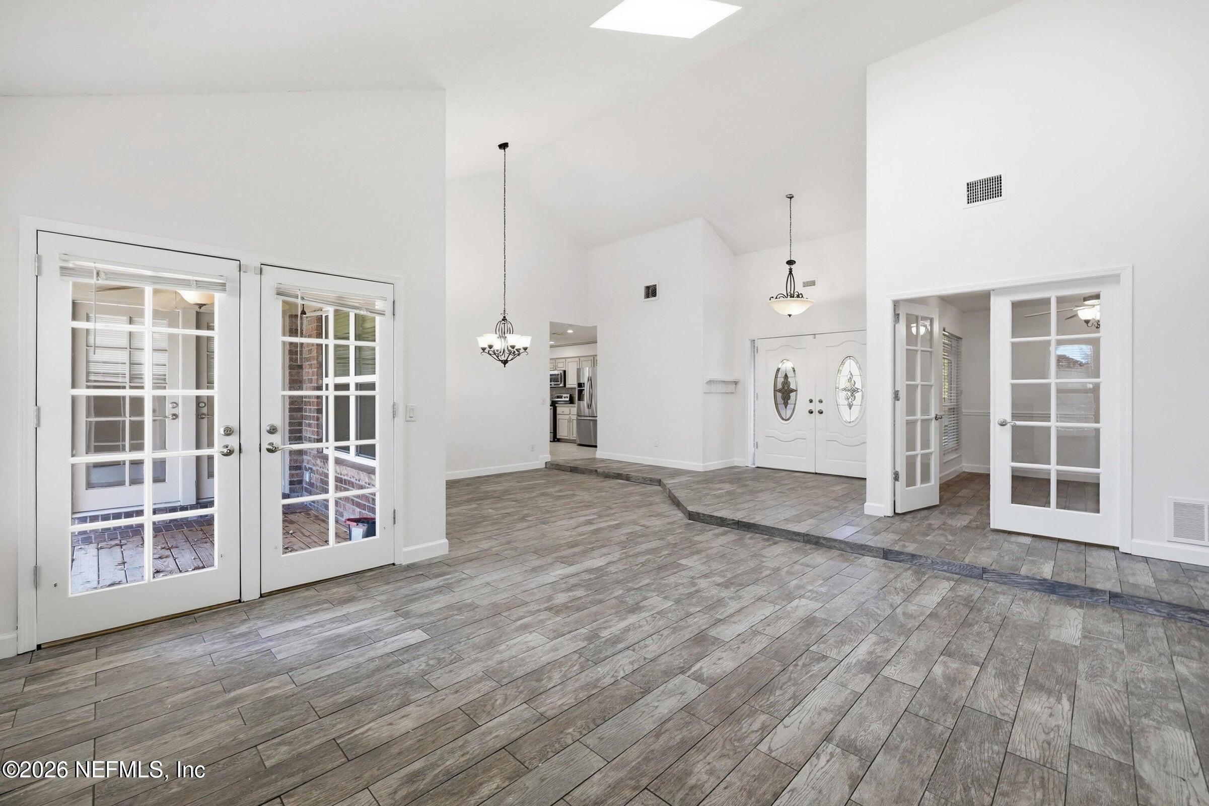 969 Alpine Ridge Court Orange Park, FL 32065 - Photo 8 of 26 a view of empty room with wooden floor and windows