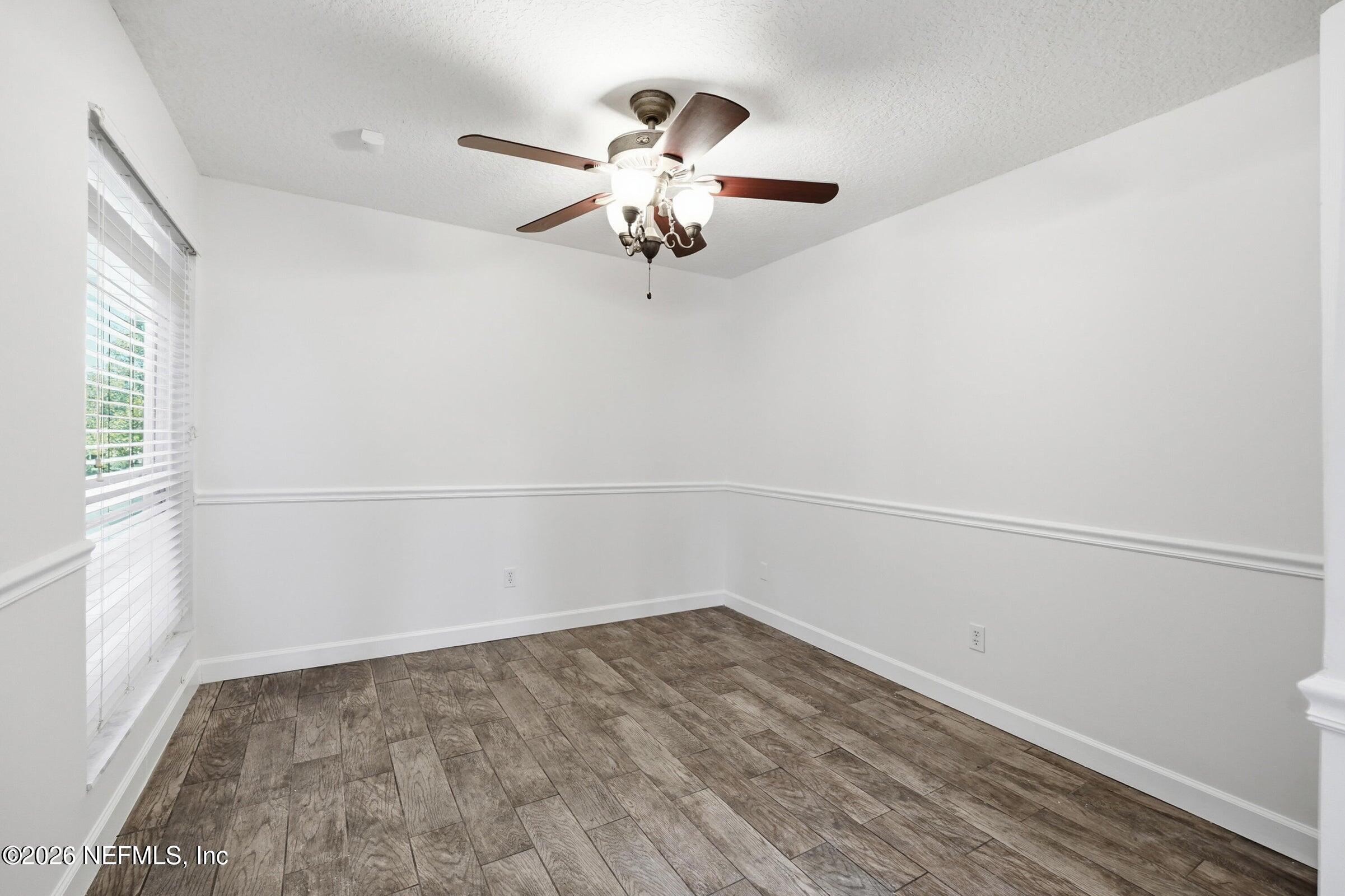 969 Alpine Ridge Court Orange Park, FL 32065 - Photo 10 of 26 a view of a room with wooden floor and ceiling fan