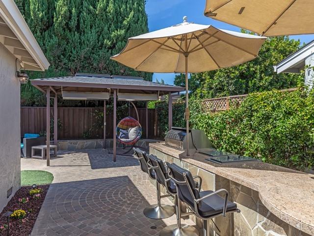 79 Del Prado Drive Campbell, CA 95008 - Photo 31 of 34 a view of a patio with a table and chairs under an umbrella