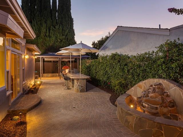79 Del Prado Drive Campbell, CA 95008 - Photo 4 of 34 a backyard of a house with table and chairs under an umbrella