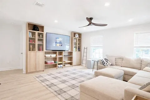 a living room with furniture potted plant and a fireplace