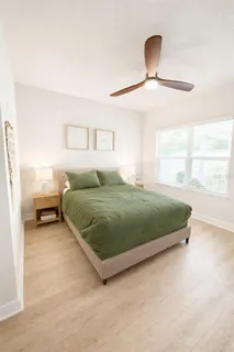 a bedroom with a bed and a window