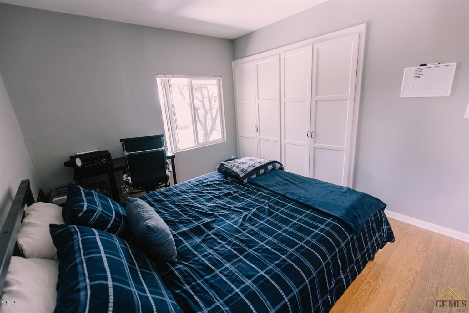 424 West Cedar Street Oxnard, CA 93033 - Photo 11 of 26 a bedroom with a bed and wooden floor