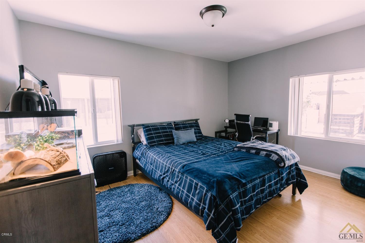 424 West Cedar Street Oxnard, CA 93033 - Photo 12 of 26 a bedroom with bed couch and window