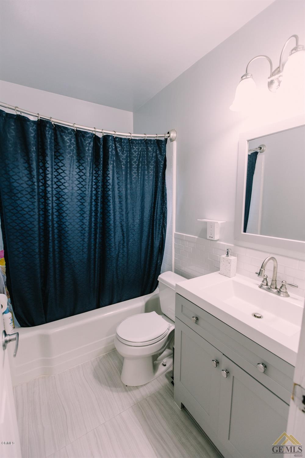 424 West Cedar Street Oxnard, CA 93033 - Photo 16 of 26 a bathroom with a sink a toilet a mirror and vanity