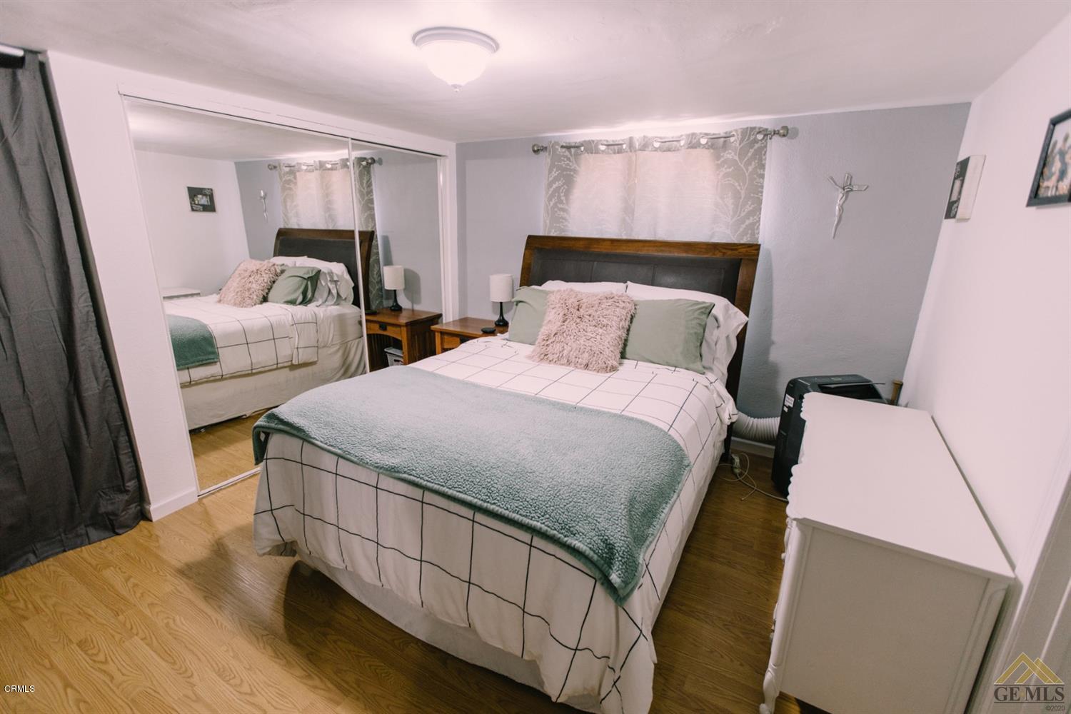 424 West Cedar Street Oxnard, CA 93033 - Photo 17 of 26 a bedroom with a bed and a mirror