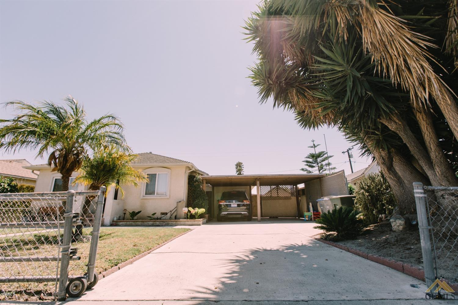 424 West Cedar Street Oxnard, CA 93033 - Photo 4 of 26 a front view of a house with a yard and garage