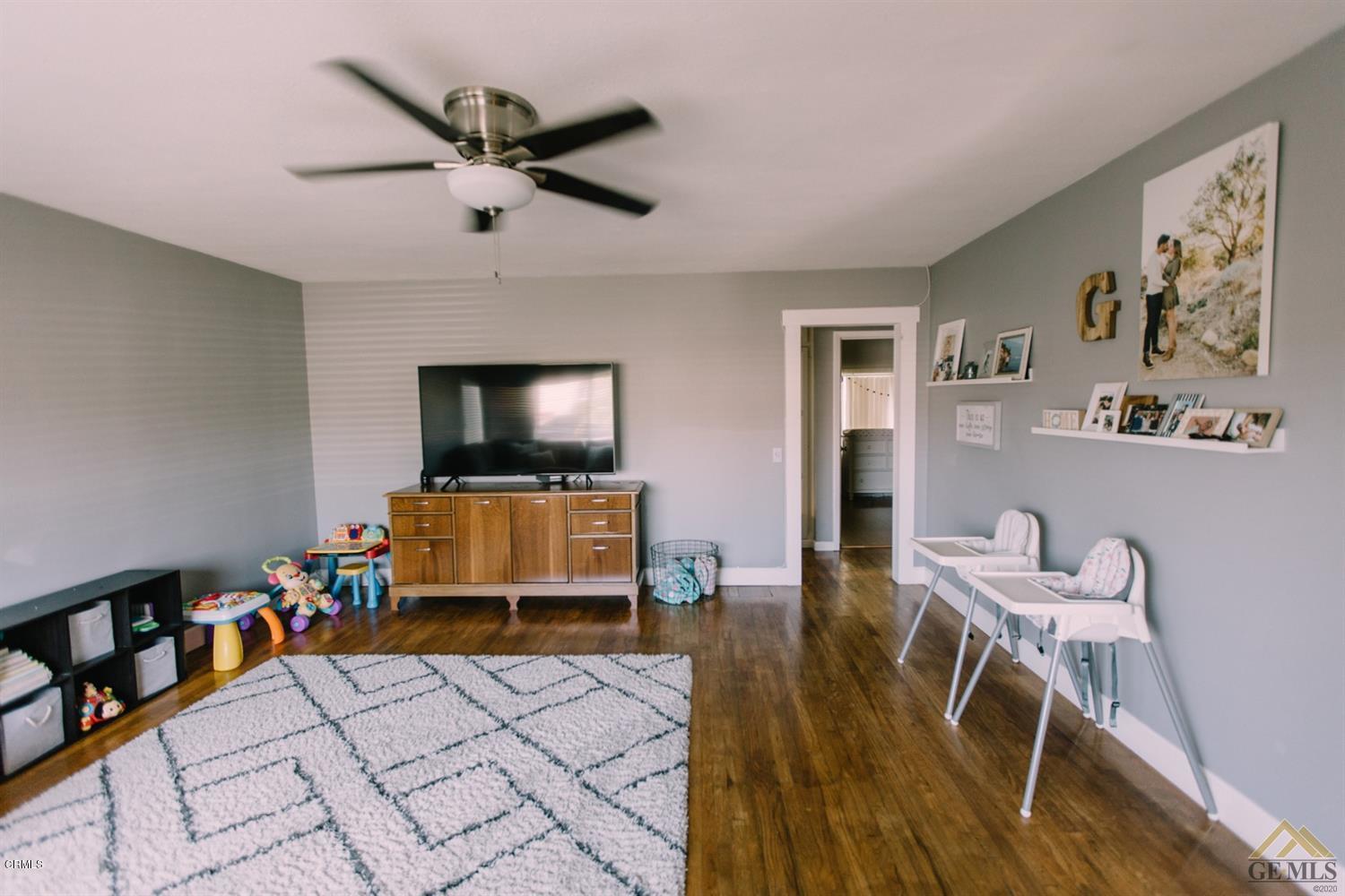 424 West Cedar Street Oxnard, CA 93033 - Photo 7 of 26 a living room with furniture and a flat screen tv